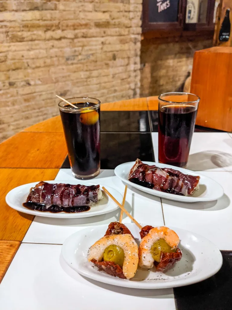 two vermut glasses and tapas at a bar in barcelona