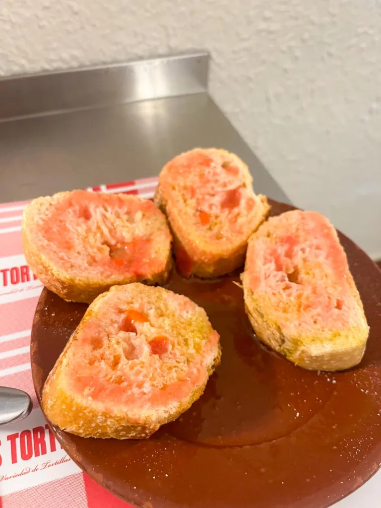 small plate with slices of pan con tomate in barcelona restaurant