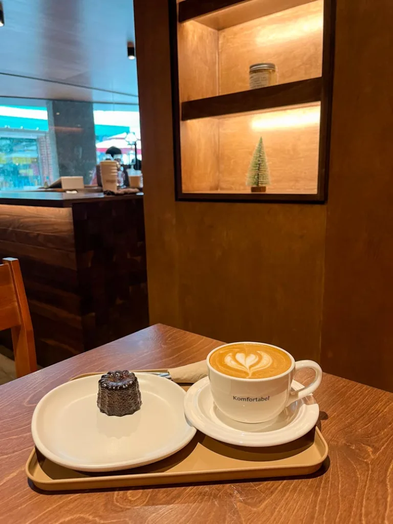 a latte and small pastry at komfortabel coffee shop in seoul