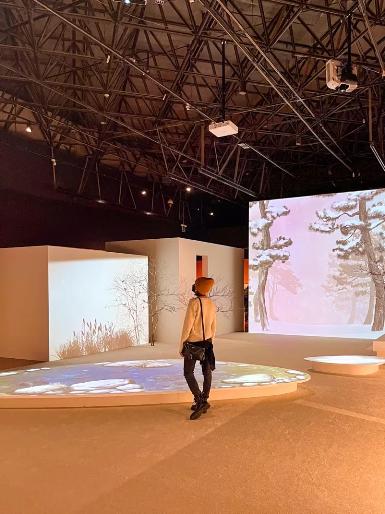Woman standing infront of an immersive exhibition at the national folk museum in seoul
