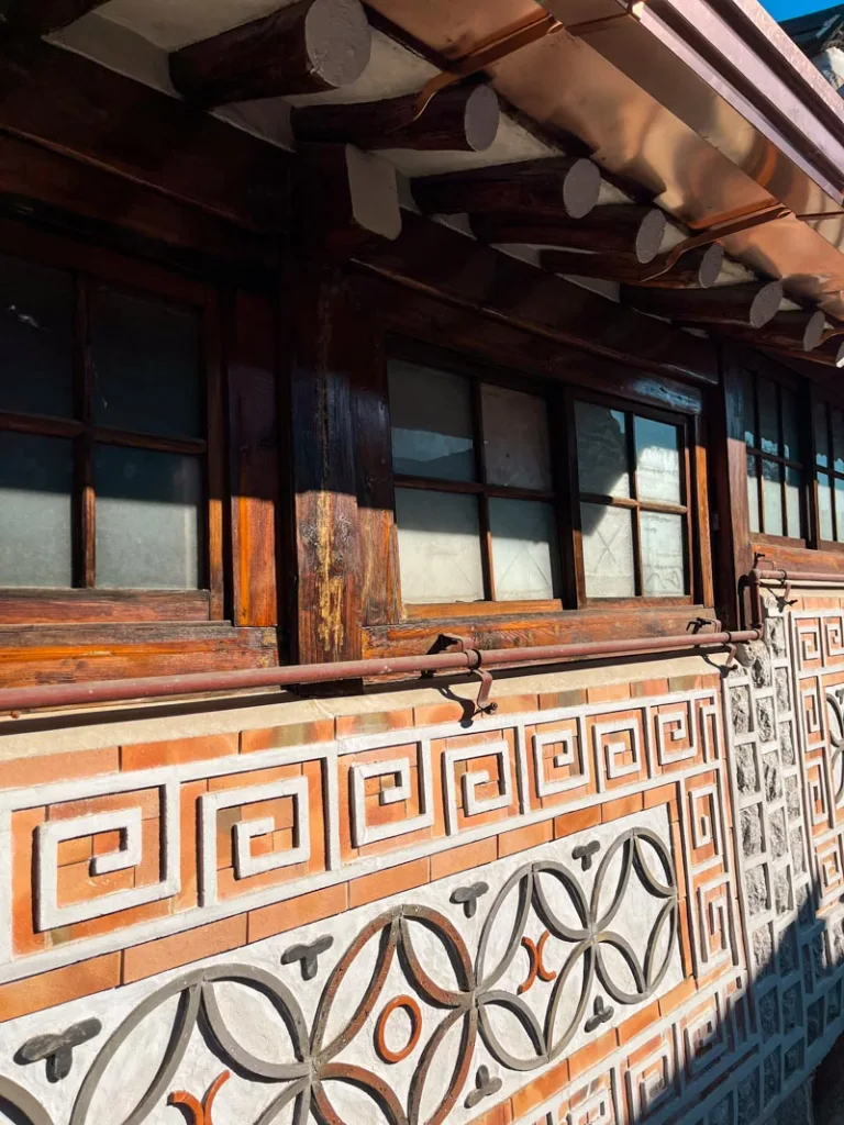 details on the side of a hanok in the buckhon hanok village guide in seoul