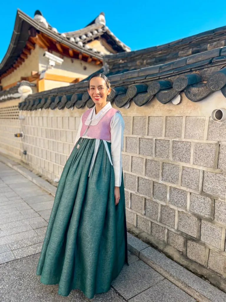 woman wearing hanbok walking around the bukchon hanok village guide