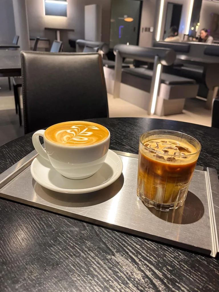 a hot latte and an iced latte on a tray at Bamvoo coffee shop in Sinsadong