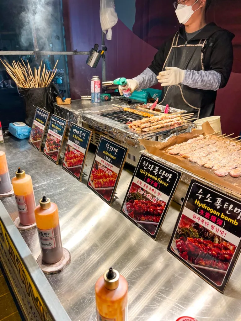 chicken skewers stand at the myeongdong night market in seoul