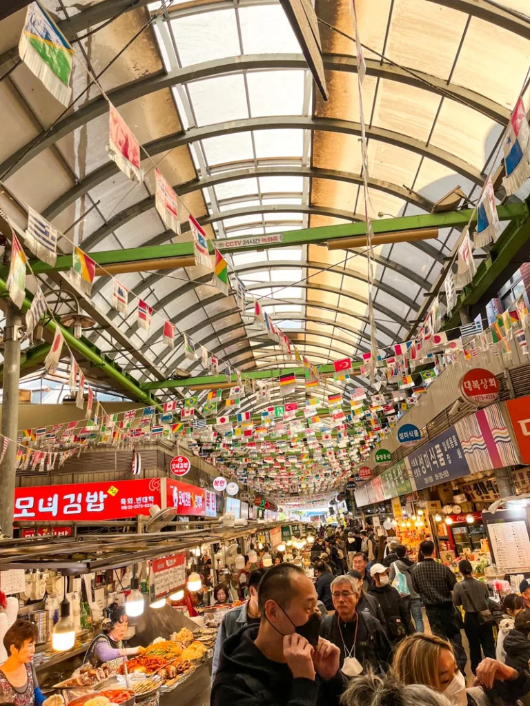 busy Gwangjang food market lined with many street food stalls in seoul