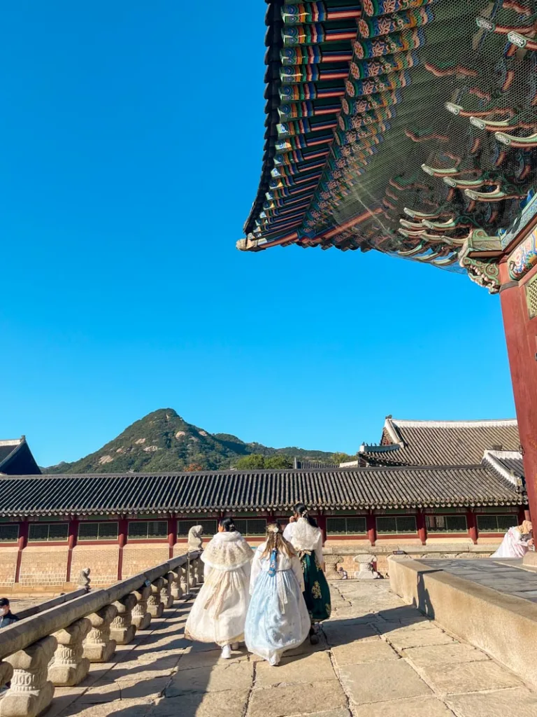 three women wearing hanbok walking the premises of the Gyeonbokgung Palace in seoul