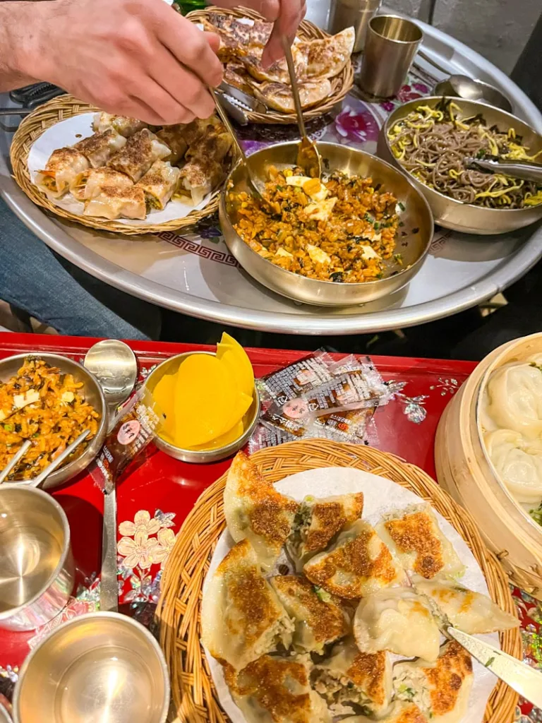 a spread of gyozas and fried rice on a table at a restaurant in ikseon-dong in seoul
