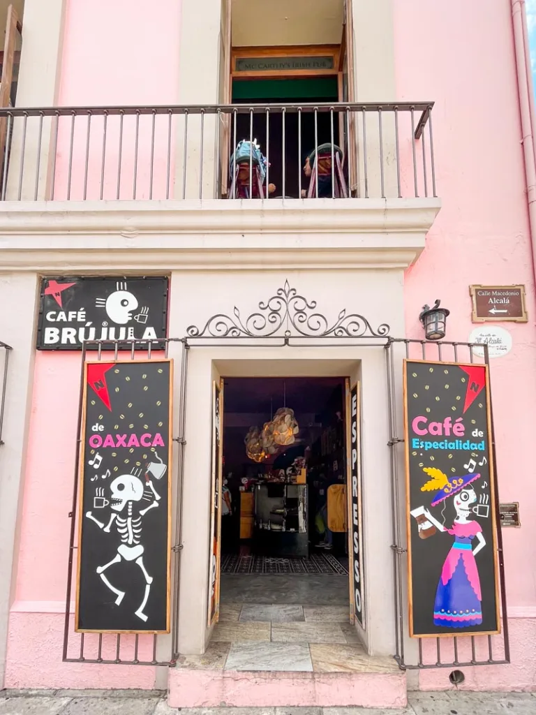 baby pink facade of a coffee shop, cafe brujula, in oaxaca city