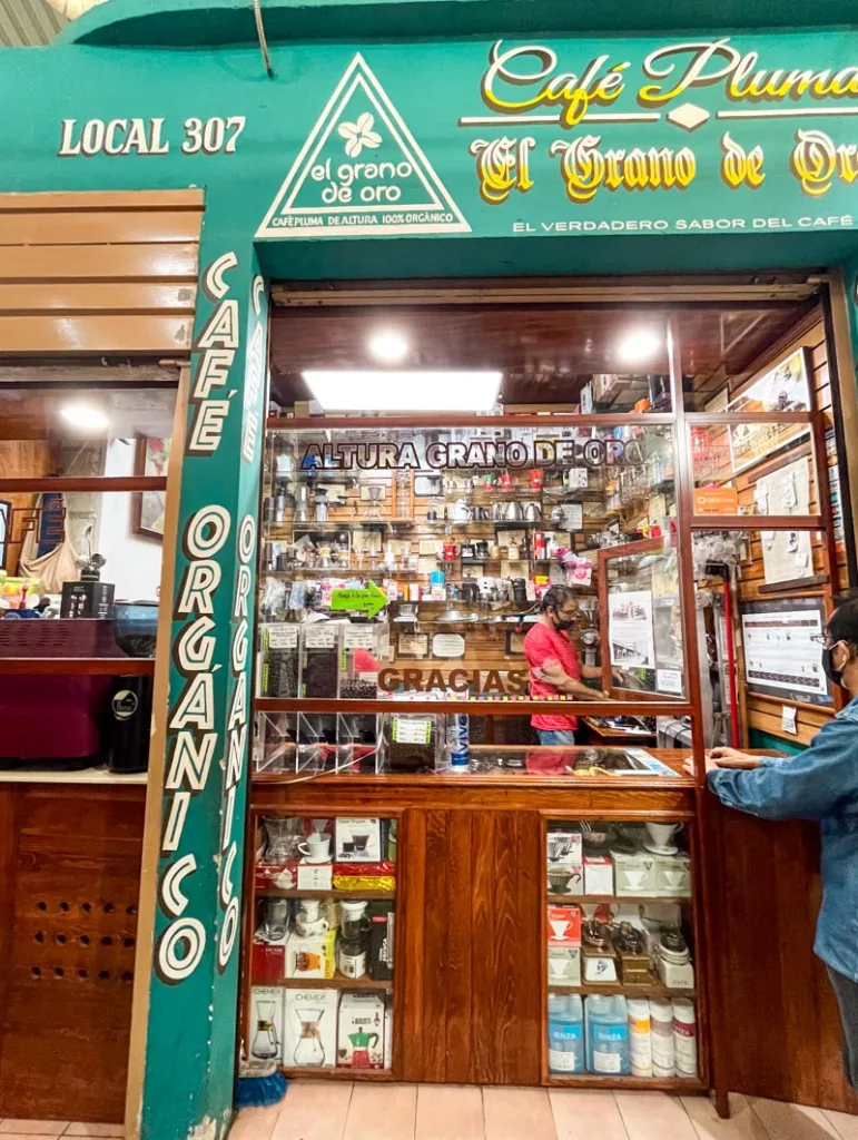green small front of a coffee selling stall "cafe el grano de oro" inside mercado 20 de noviembre in oaxaca city