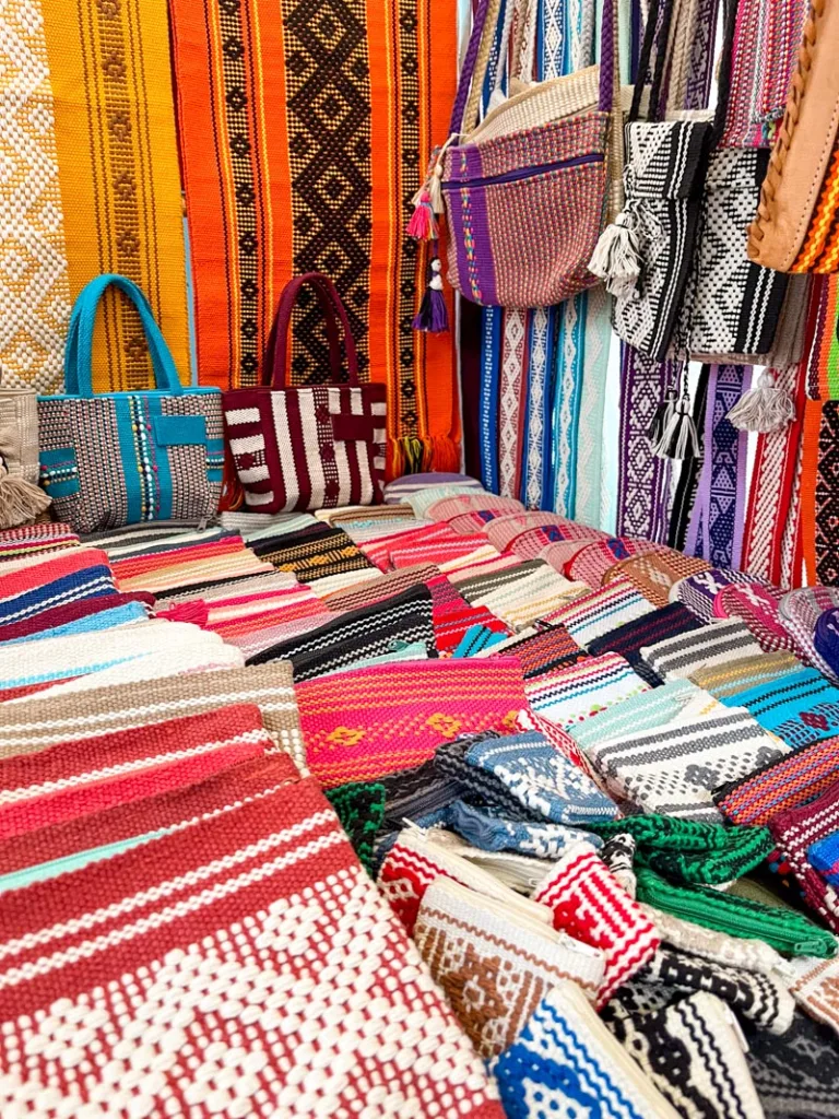 woven pouches and bags on display at a street market in oaxaca city