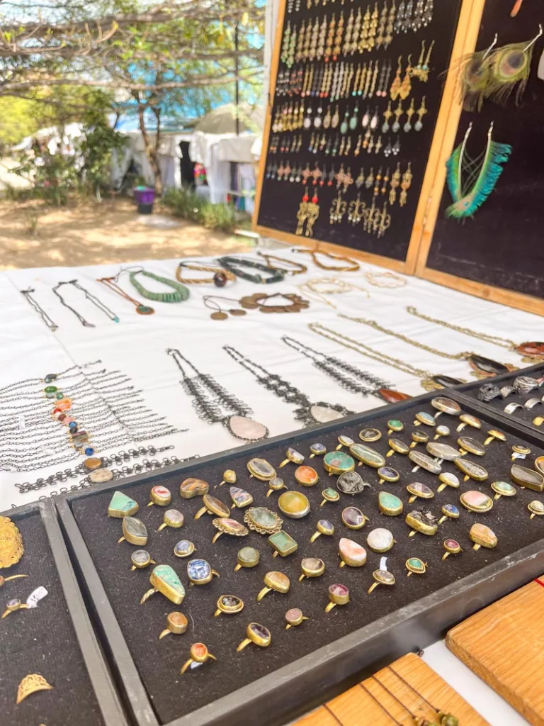 handmade jewelry on display on a table at a street market in oaxaca city