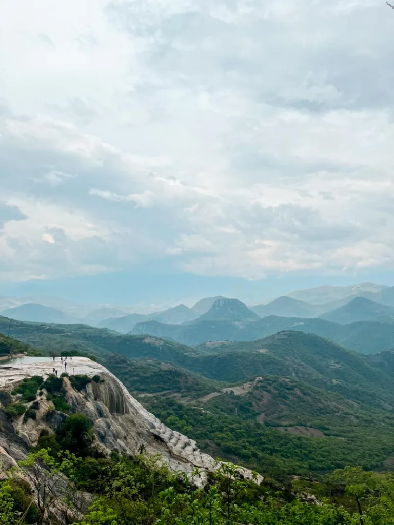 panoramic view of the petrified waterfalls in hierve el agua, oaxaca surrounded by green hills