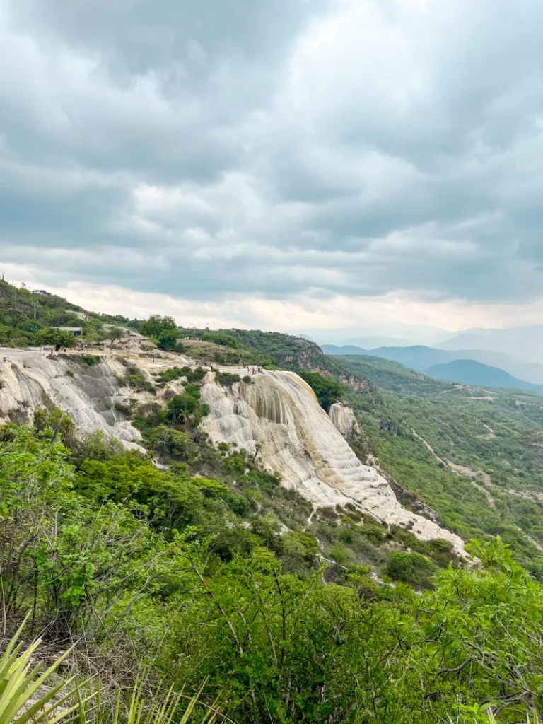 panoramic view of the petrified waterfalls in hierve el agua, oaxaca surrounded by green hills