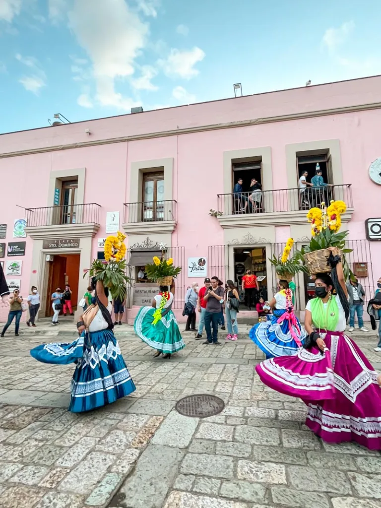 Mexican folkloric dancers dancing through the streets in oaxaca city with big colorful skirts