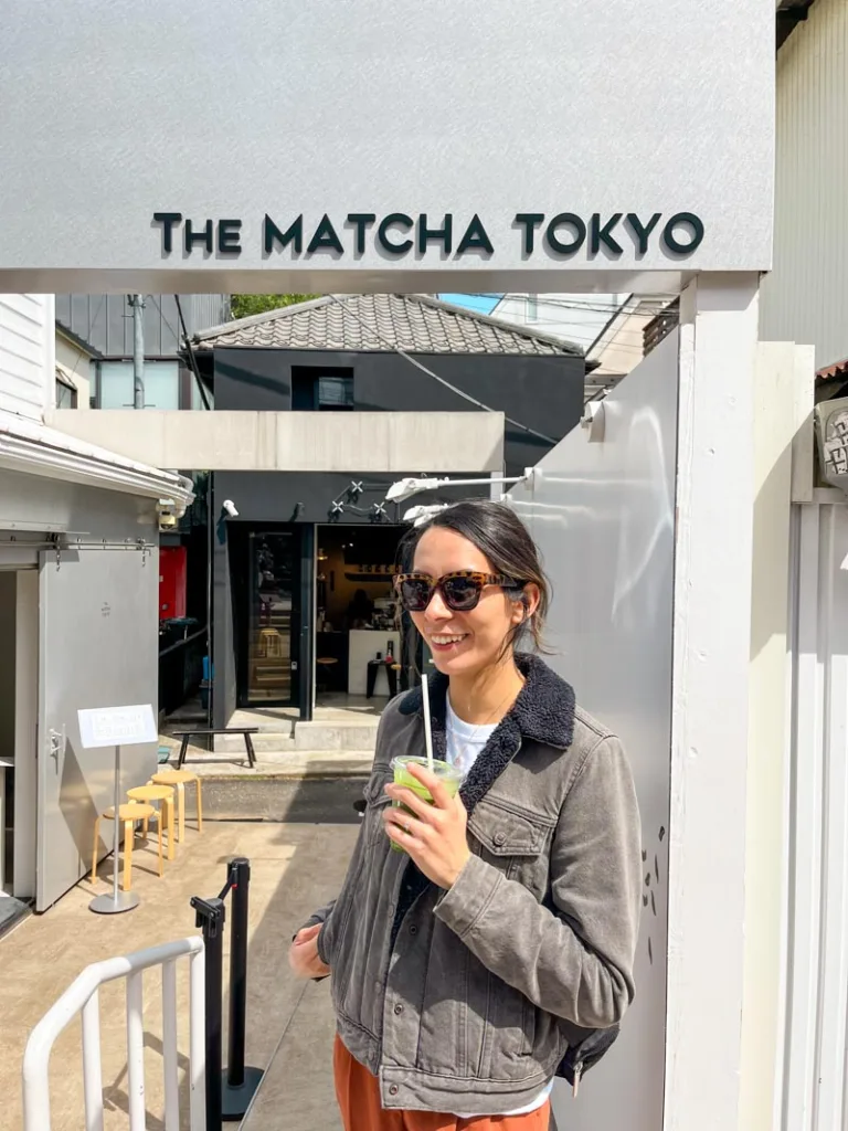 Woman holding an iced matcha latte outside of Matcha tokyo