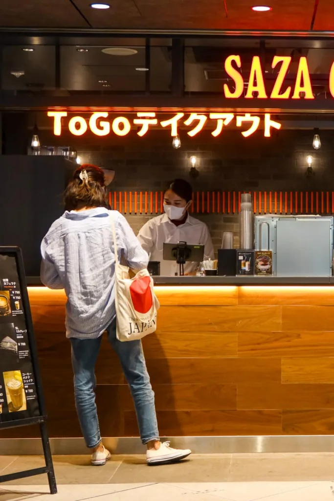 woman ordering at the cashier of saza coffee shop in tokyo