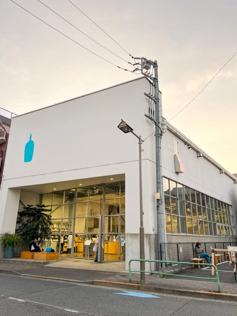 a warehouse-looking blue bottle coffee shop in tokyo