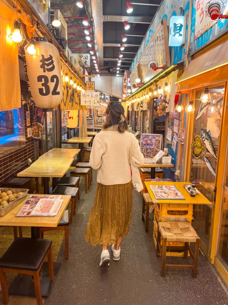 Woman walking through a Japanese indoor food hall in Tokyo