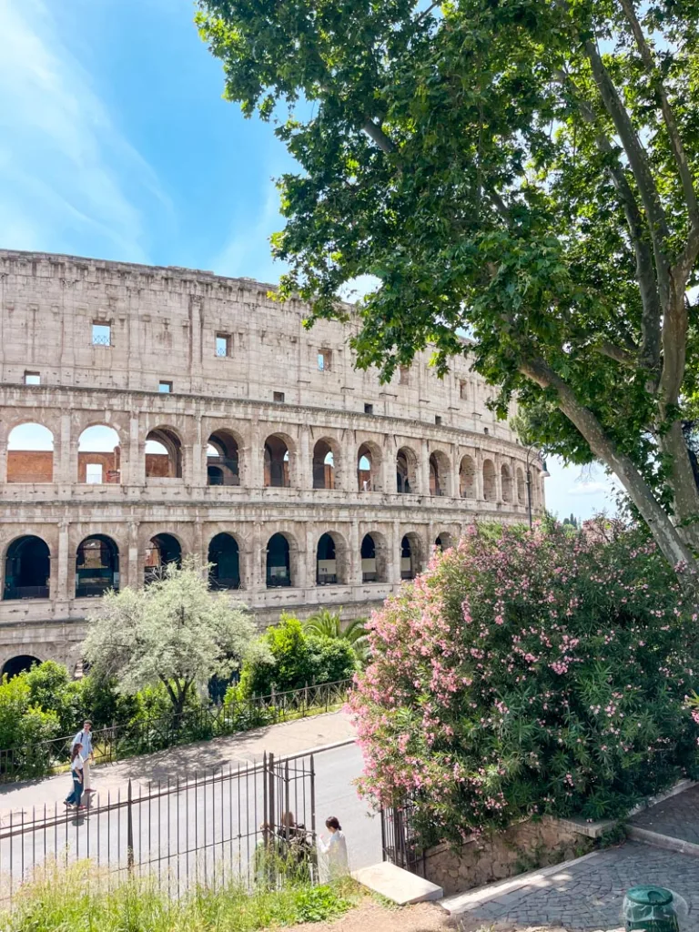 view of the roman colosseum from a high hill on parco del colle oppio