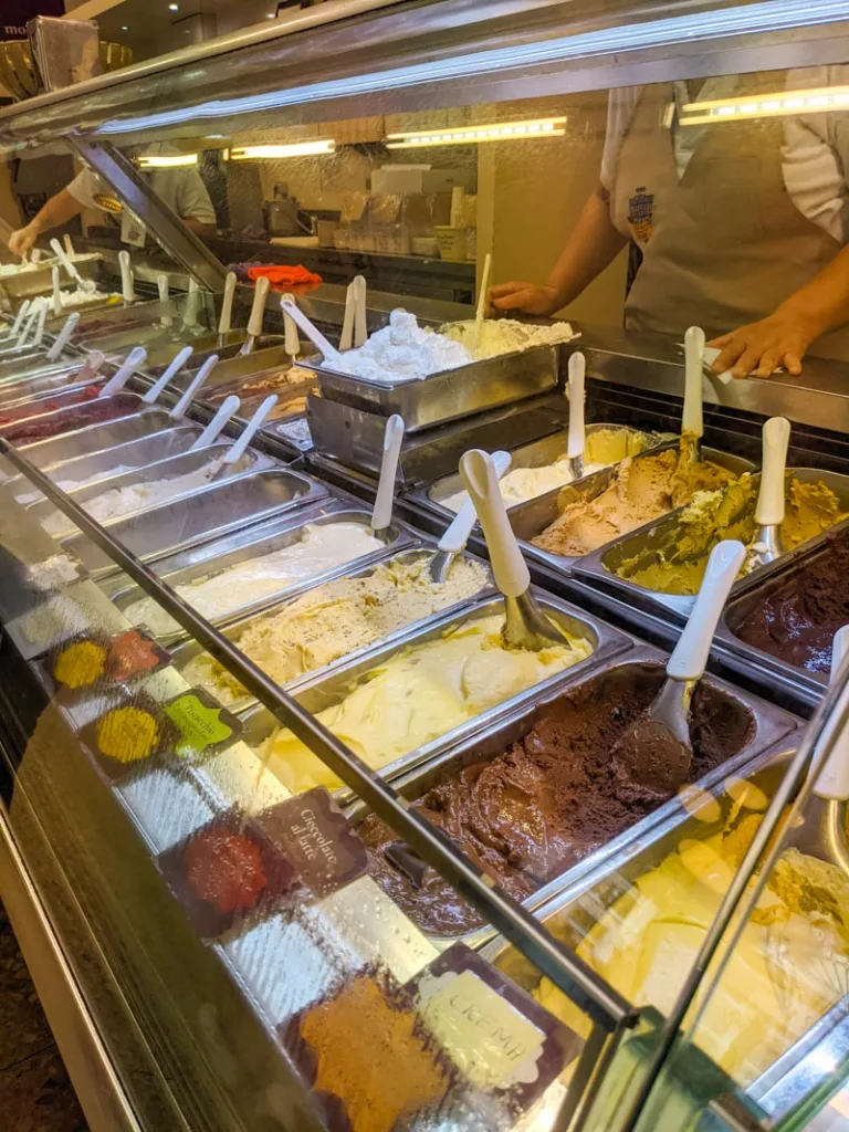 multiple gelato flavors on display at gelateria fassi in esquilino, rome