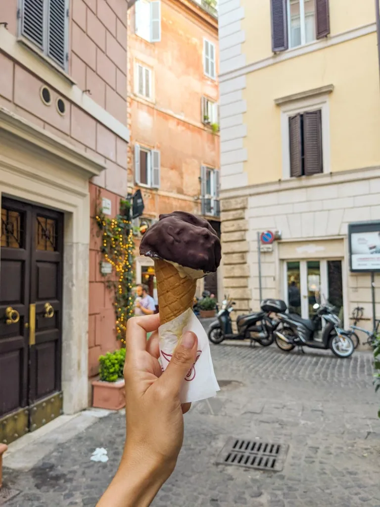 hand holding a chocolate covered gelato cone from gelato frigidarium in rome