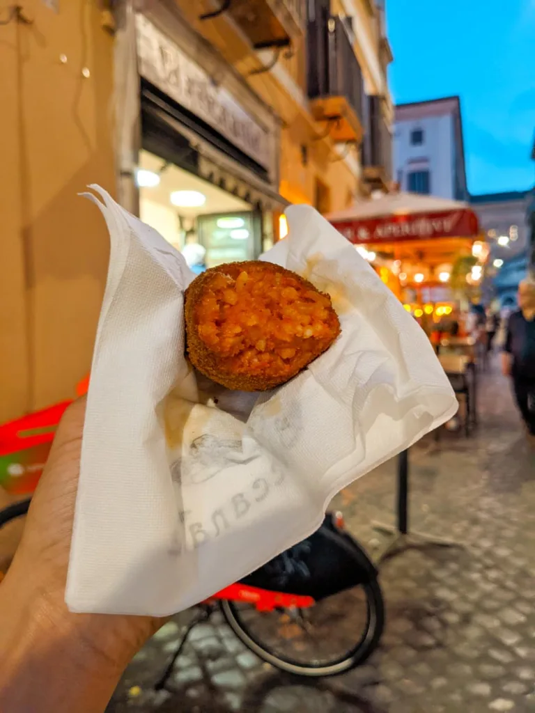 hand holding a suppli from il baccanalle in rome