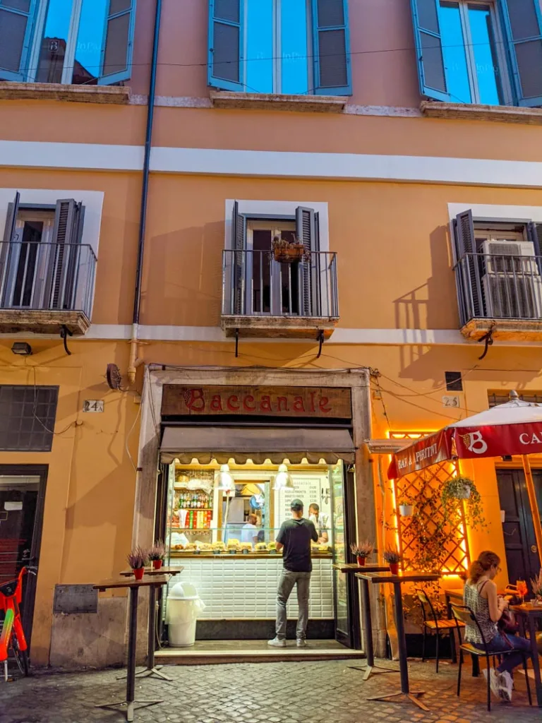 lit up little food stand on an evening in rome