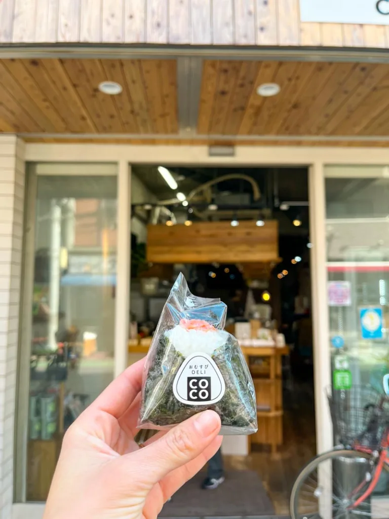 hand holding a homemade onigiri from a shop in nakameguro, tokyo