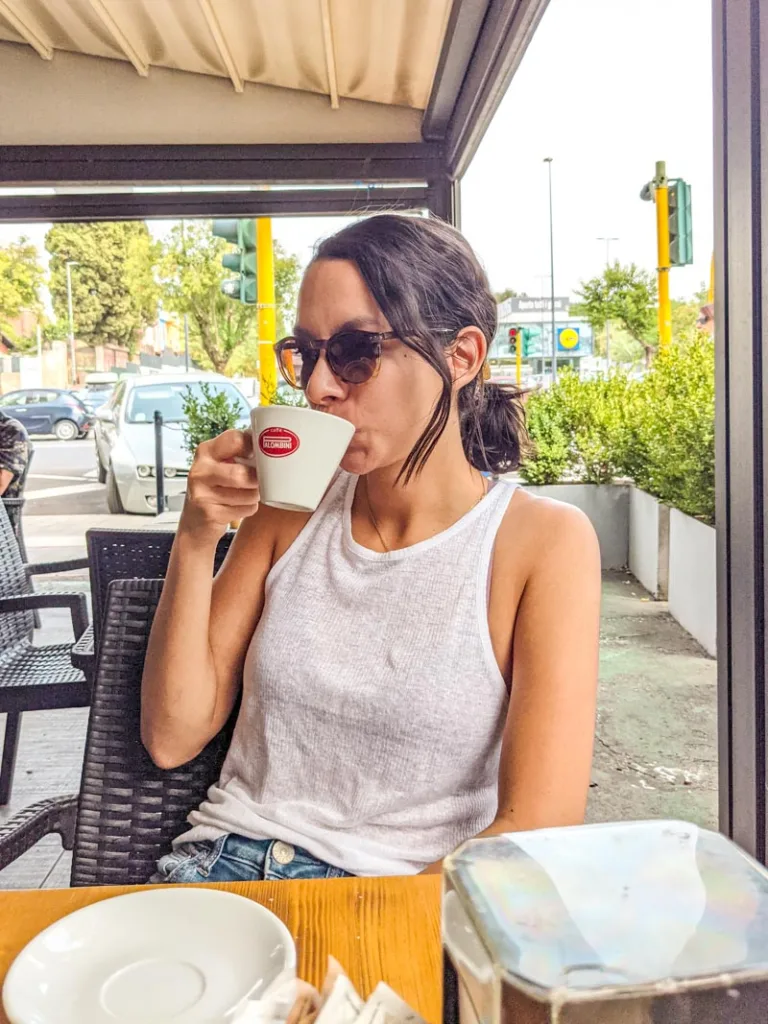woman sipping on a cappuccino at pezzoti gelateria in rome