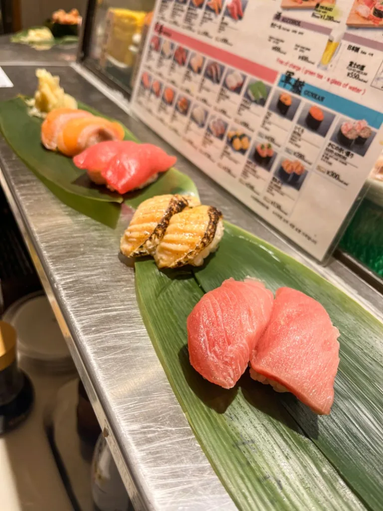 assortment of sushi served on a big leave at a sushi bar in shimbashi, tokyo