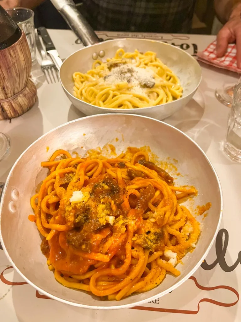 two bowls of thick spaguetti at tonnarello restaurant in rome