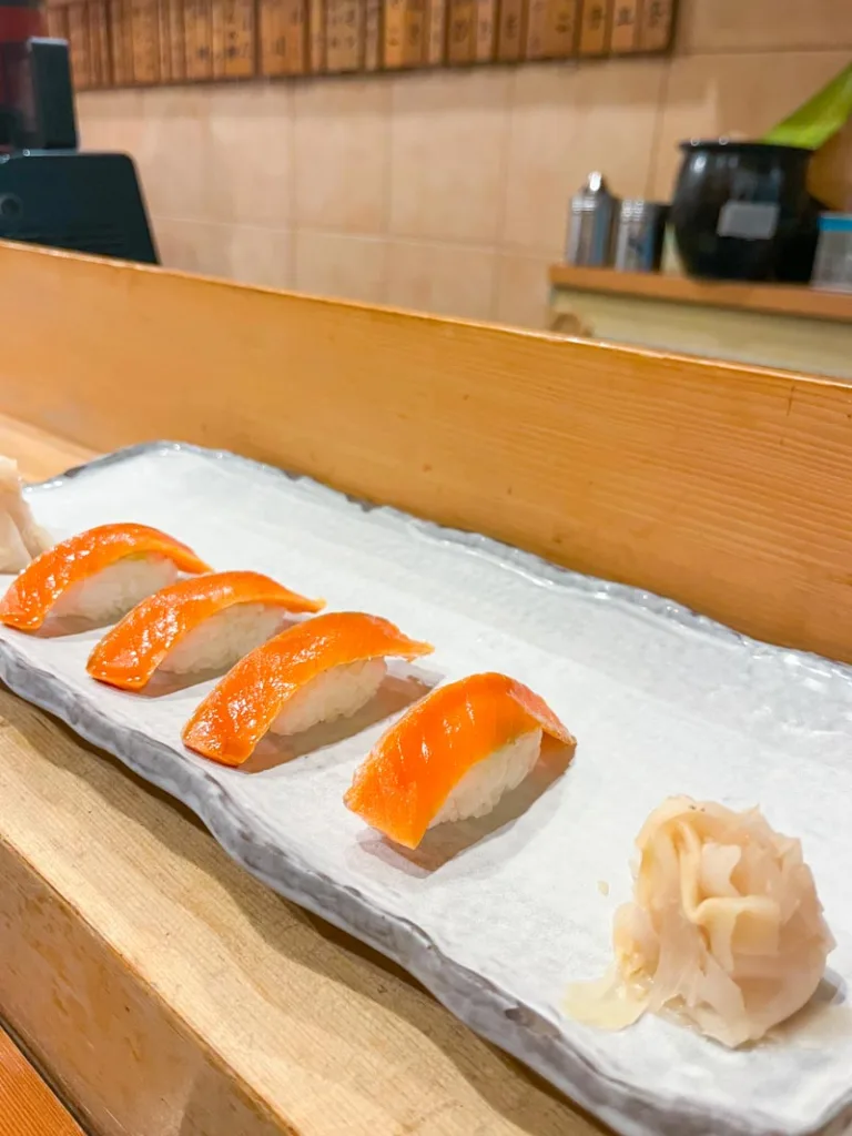 salmon sushi on a plate at a restaurant in tsukiji fish market in tokyo