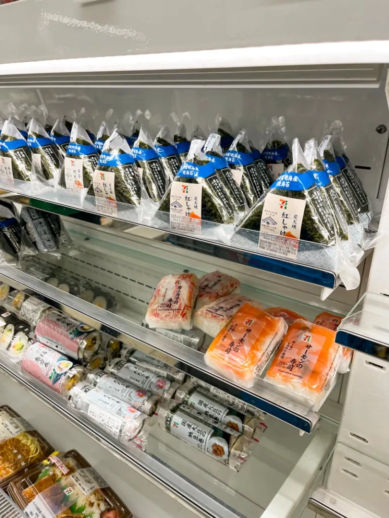 onigiri on display on a fridge's shelf in 7-eleven in tokyo