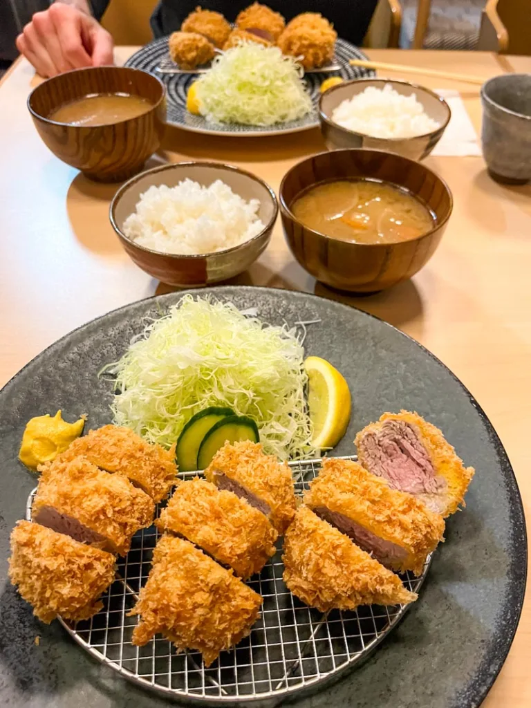 slices of thick tonkatsu, a side miso soup and rice bowl at horiichi restaurant in tokyo