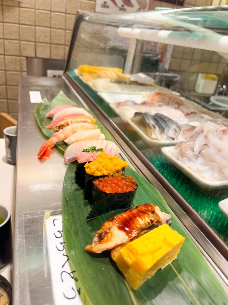 assortment of sushi served on a big leave at a sushi bar in shimbashi, tokyo