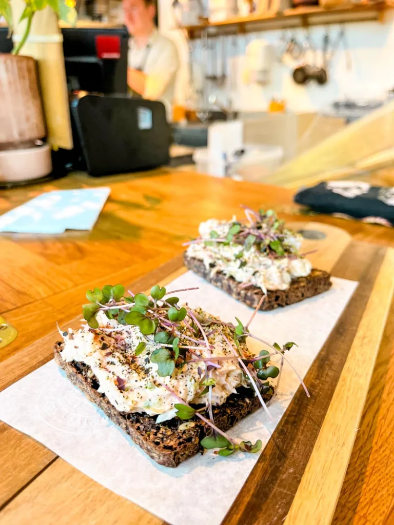 two tuna smorrebrod on a wooden board at rort restaurant in copenhagen