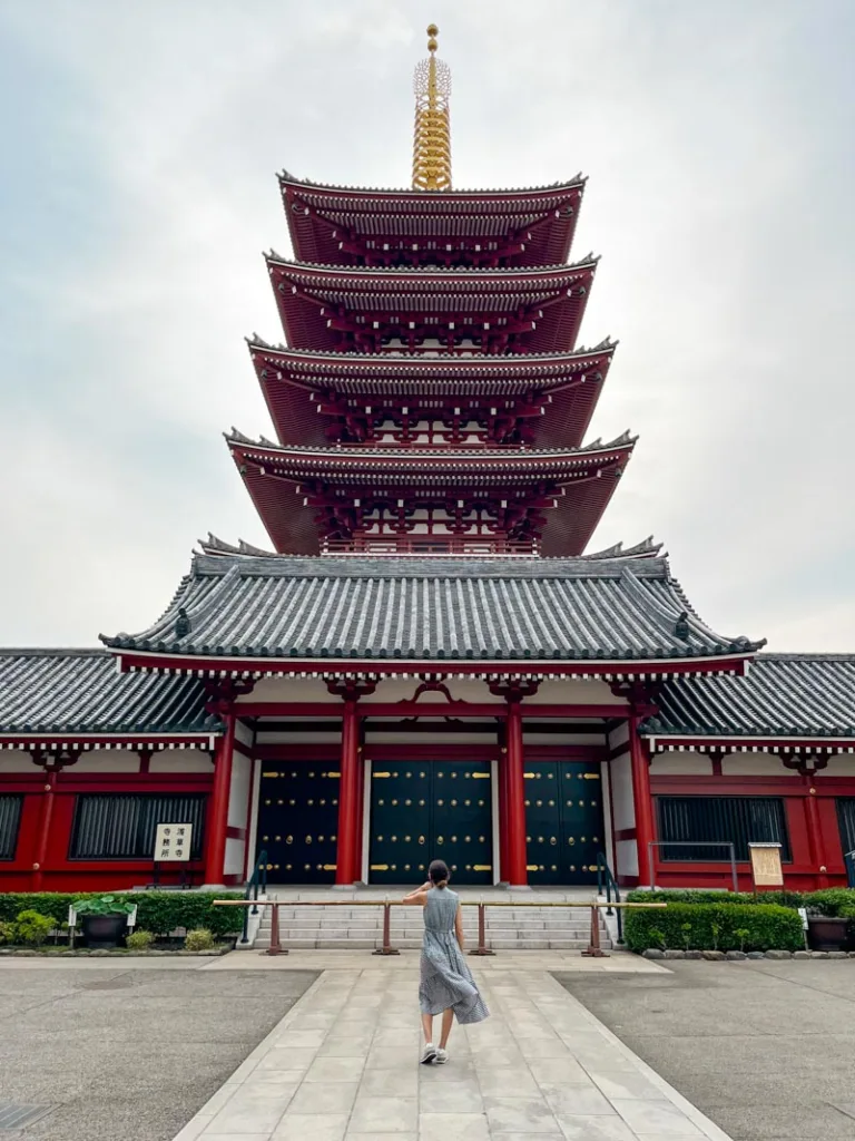 woman standing in front of a temple in asakusa, a must-visit in a 5-day tokyo itinerary
