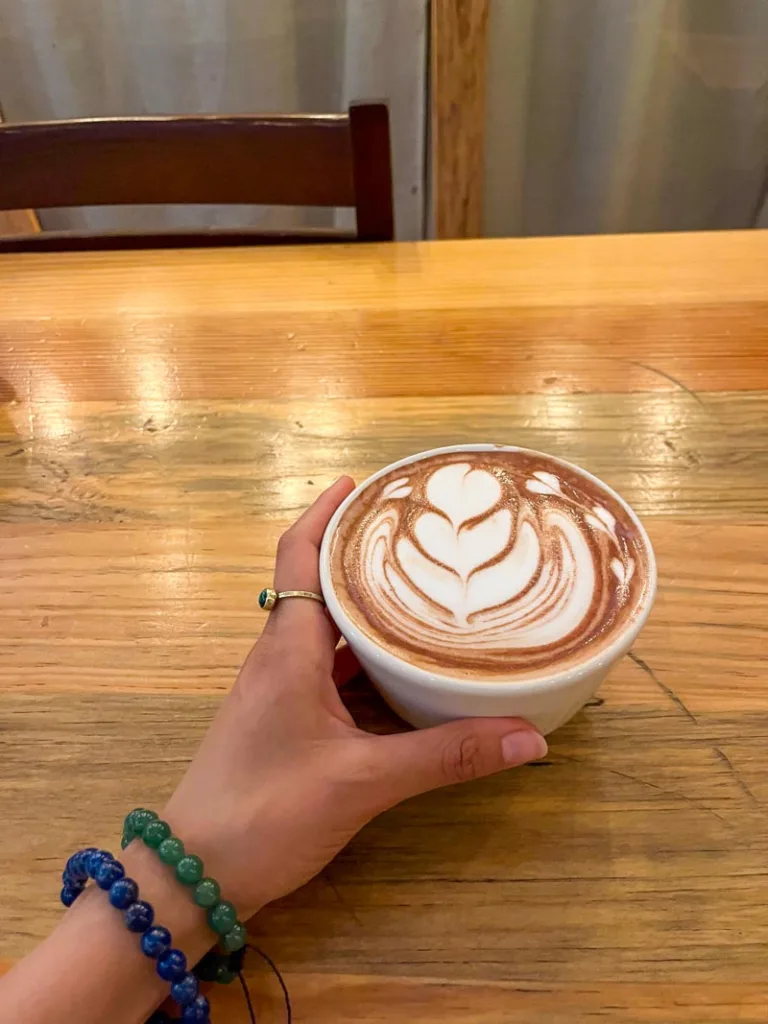 hand holding a hot chocolate cup at oaxaca en una taza in oaxaca city
