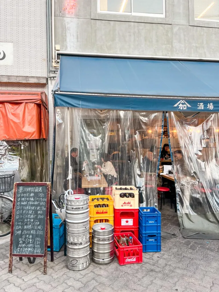 kegs and beer boxed outside a casual restaurant in hoppy street, tokyo