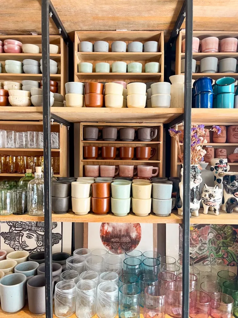 shelves packed with colorful ceramics at marias arte and diseno artisanal shop in oaxaca city