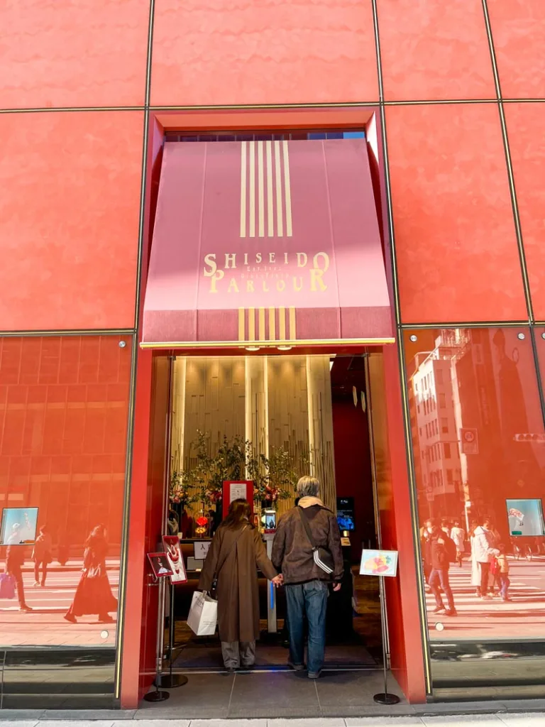burnt red walls and entrance to the shiseido parlour in ginza, tokyo