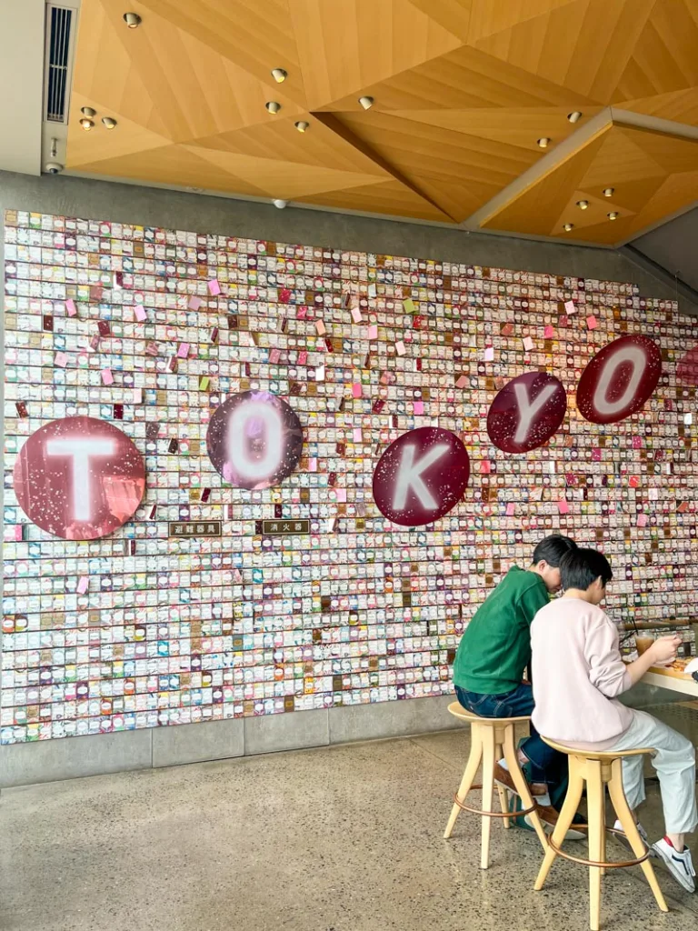 pink tokyo sign on the wall at the starbucks roastery in nakameguro, tokyo