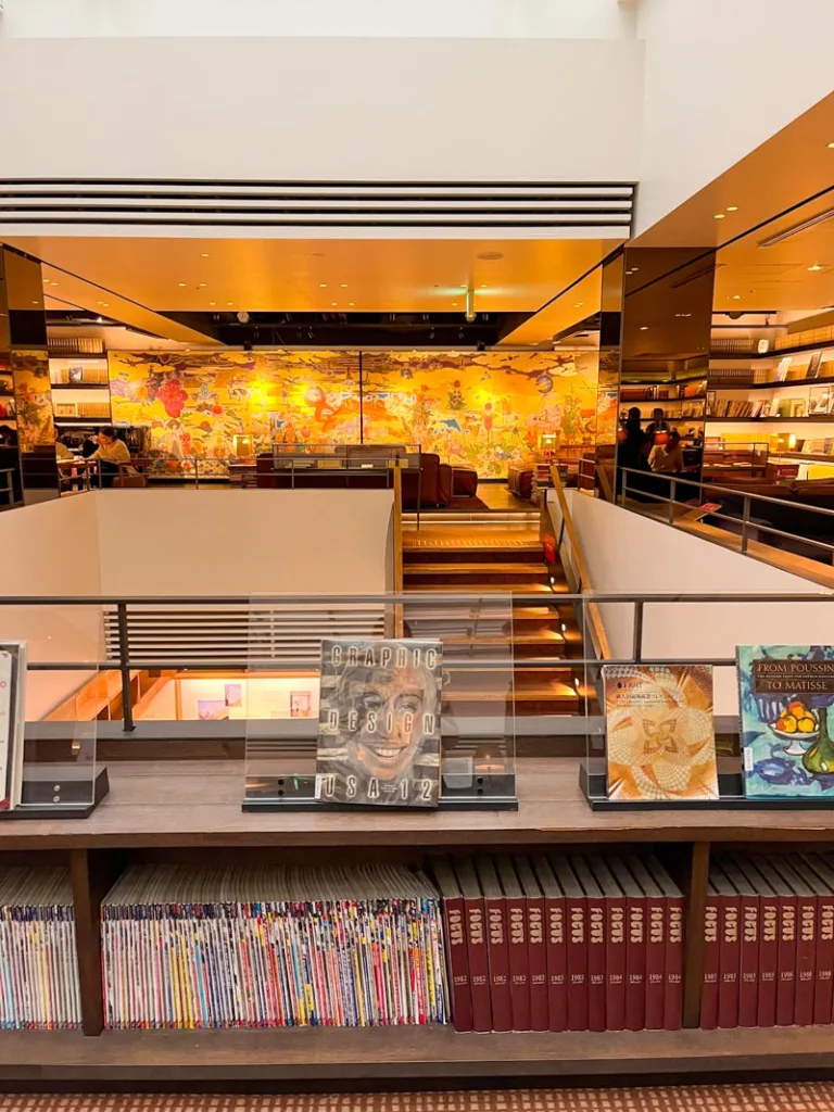 low shelf stacked with books and magazines at a cozy lounge inside the tsutaya bookshop in tokyo