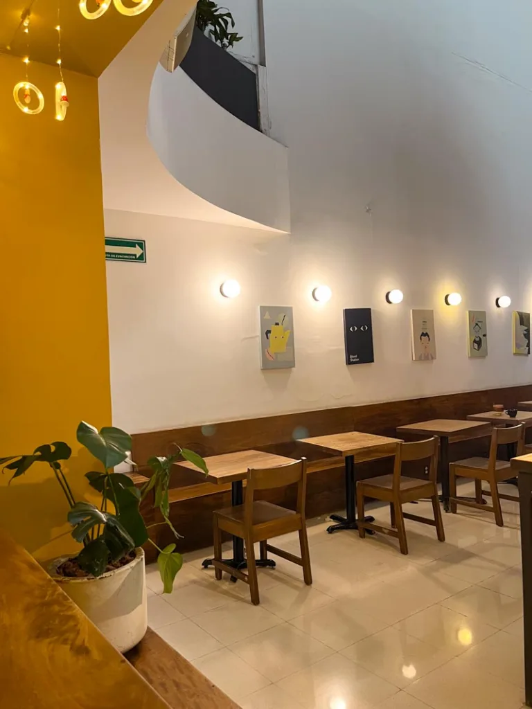 wooden tables next to a long wooden bench at blend, one of the best coffee shops to work in mexico city