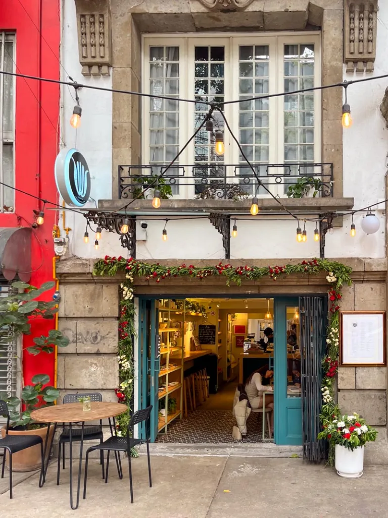 cute facade of a coffee shop in mexico city in a colonial buildling