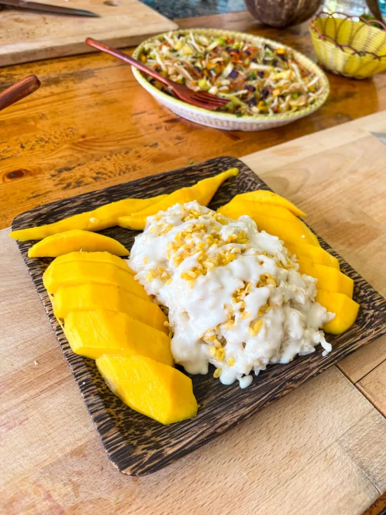 Sticky mango dish on a wooden board at a cooking class in koh tao, thailand