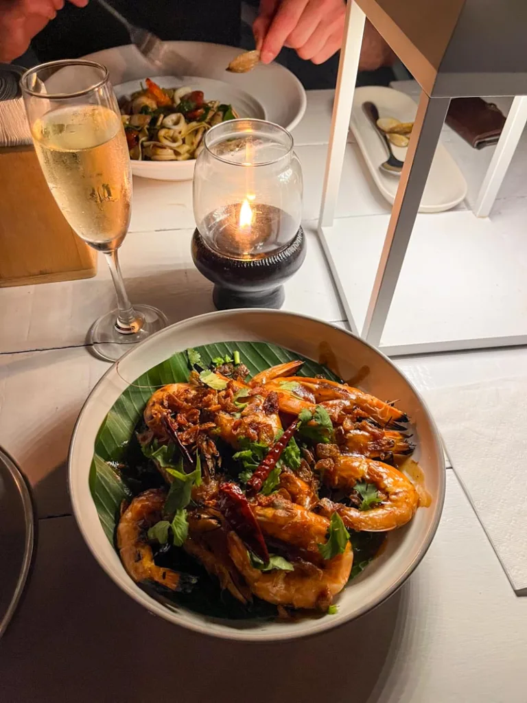 plate of prawns and a glass of prosecco at whitening restaurant in koh tao thailand