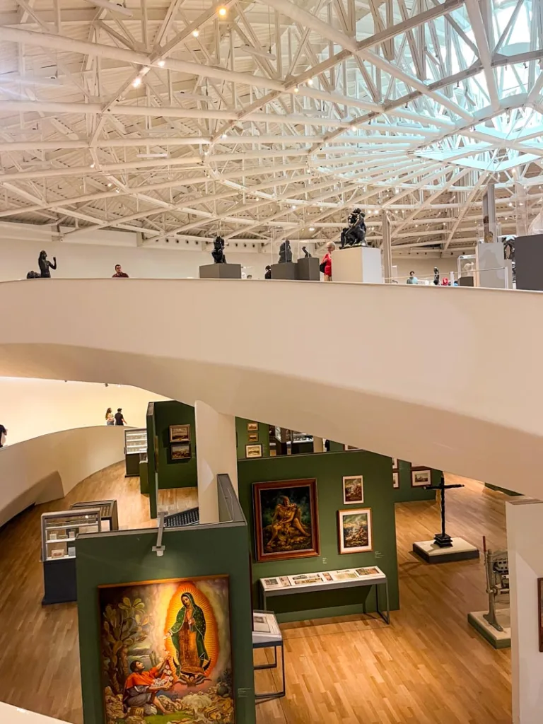 view of paintings one floor below, inside museo soumaya in mexico city