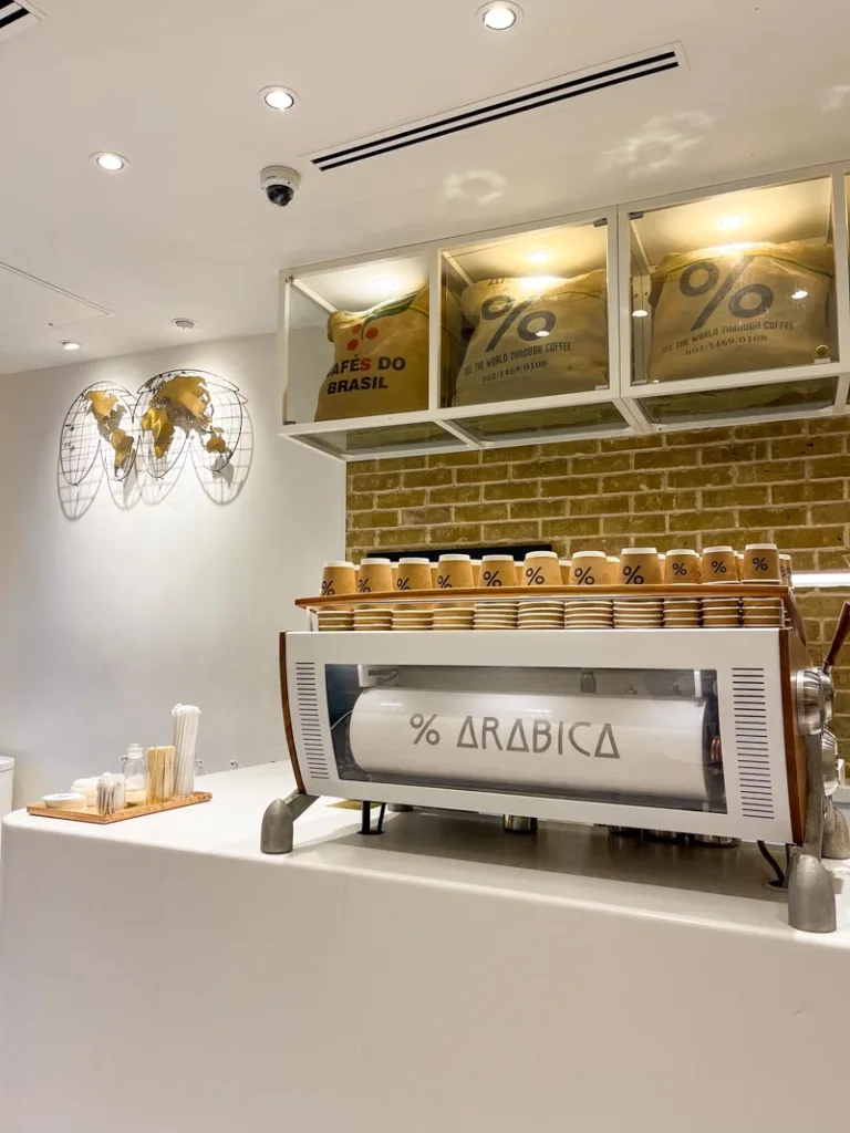 minimalist white interior and coffee bar at %arabica coffee shop in covent garden, london