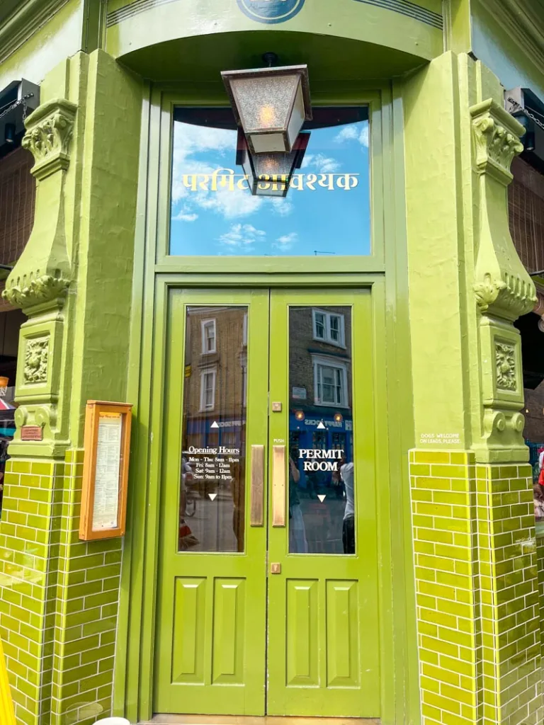 vibrant green facade of dishoom restaurant in notting hill, london